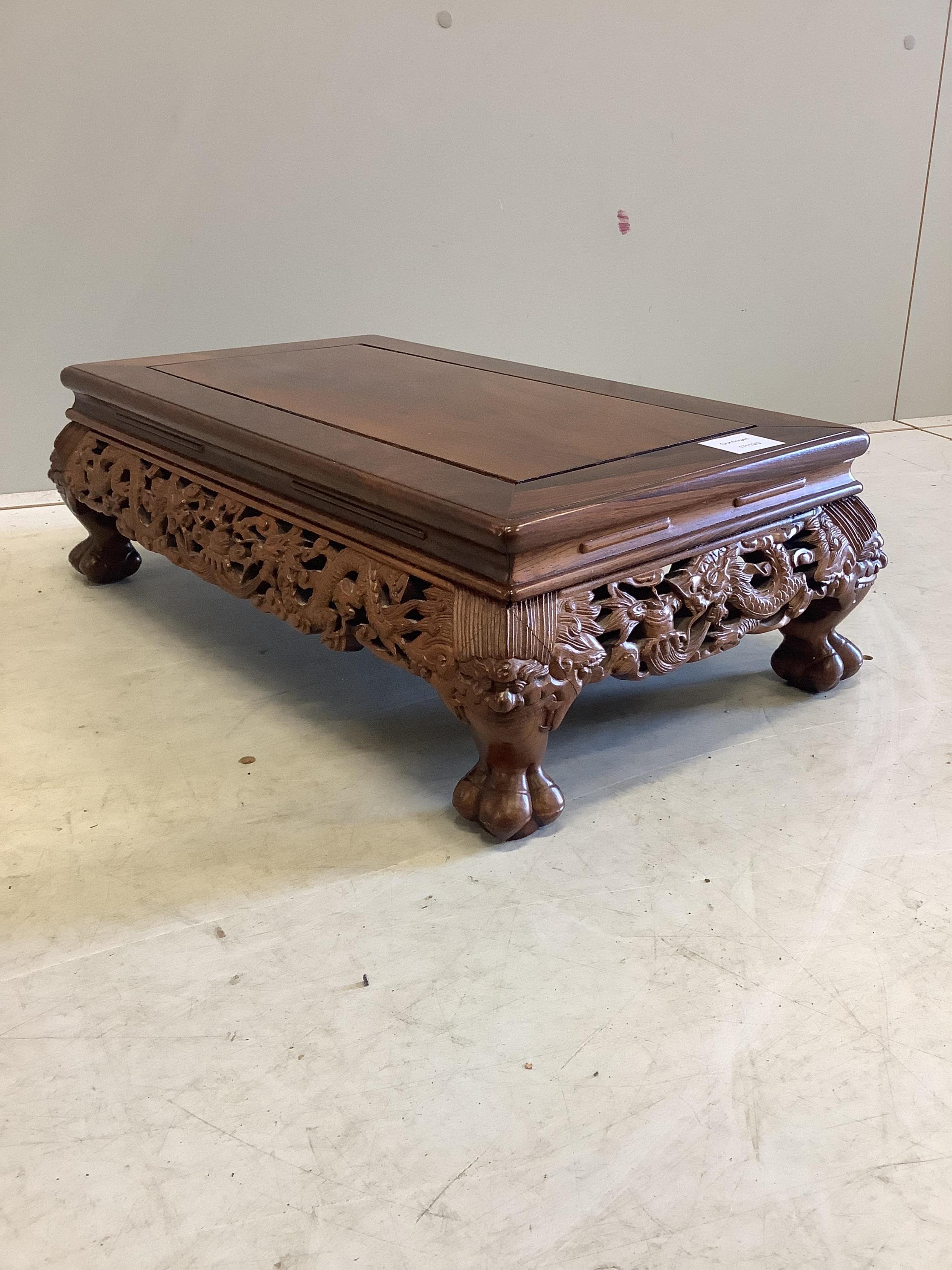 A Chinese rectangular rosewood stand or low table, width 56cm, depth 33cm, height 18cm. Condition - good